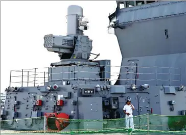  ?? AFP ?? A Japanese navy crew member stands on the flight deck of the JS Izumo naval ship. The cost of refurbishi­ng the destroyer Izumo for operating fighter jets is included in the Japanese defence ministry’s request.