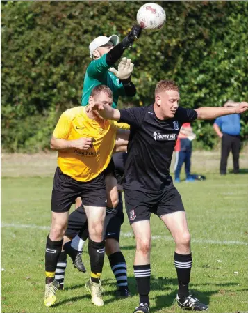  ??  ?? Newtown United goalkeeper Ken Turner punches the ball clear.