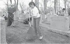  ?? MICHAEL THOMAS, GETTY IMAGES ?? Volunteers clean up Chesed Shel Emeth Cemetery in Missouri. The cemetery was one of the latest targets of vandalism.