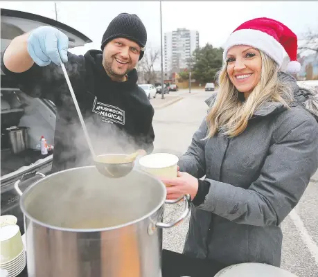  ?? PHOTOS: DAN JANISSE ?? Windsor lawyer Helen Burgess spread some holiday spirit on Tuesday as she and other volunteers set up at the corner of University and Bruce avenues and handed out hot soup, clothing and other items. Denis Vidmar from the Magical Mushroom Hub provided the soup and is shown with Burgess during the event. “Anything you can do to brighten someone’s day, even if it’s something small, is worth doing,” Burgess said.