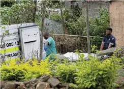  ?? ?? Police remove a body of one of the nine suspects they shot in Mariannhil­l.