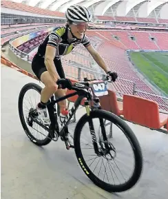  ??  ?? HAVING A BALL: Mandela Bay Mountain Bike Challenge 36km women’s winner Andrea Shirley races through the NMB Stadium at the weekend