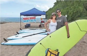  ?? GARY PORTER / FOR THE MILWAUKEE JOURNAL SENTINEL ?? Alaina and Jake Bresette, owners of Lake Effect Surfshop in Shorewood, have begun setting up a tent on Atwater Beach in Shorewood on Saturdays where they rent surfboards, paddle boards and other items.