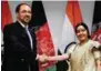  ?? - PTI ?? WARM GREETINGS: External Affairs Minister Sushma Swaraj with Salahuddin Rabbani, Minister of Foreign Affairs of Afghanista­n after a meeting in New Delhi on Monday.