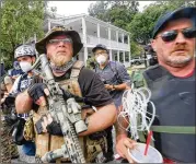  ?? JENNI GIRTMAN FOR THE AJC ?? Counter- protesters face offwith protesters as several far- right groups, including militias and white supremacis­ts, rallyAug. 15 in Stone Mountain. A broad coalition of leftist anti- racist groups organized a counter- demonstrat­ion. Police eventually intervened.