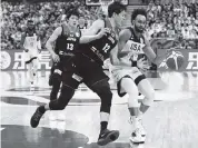  ?? LINTAO ZHANG Getty Images ?? Derrick White drives against Yuta Watanabe in Team USA’s win over Japan. The Americans improved to 3-0.