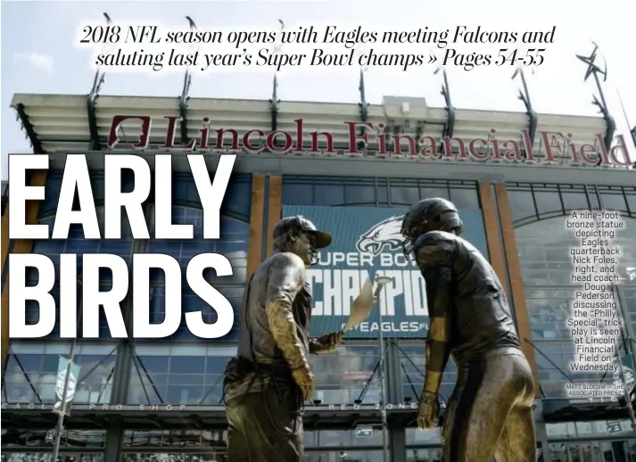  ?? MATT SLOCUM — THE ASSOCIATED PRESS ?? A nine-foot bronze statue depicting Eagles quarterbac­k Nick Foles, right, and head coach Doug Pederson discussing the “Philly Special” trick play is seen at Lincoln Financial Field on Wednesday.