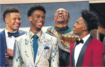  ?? MIKE STOBE/GETTY IMAGES ?? Stylish Hamilton guard Shai Gilgeous-Alexander, second from left, stays loose before the draft with fellow NBA prospects Kevin Knox, left, Wendell Carter Jr. and Collin Sexton at the Barclays Center on Thursday. Gilgeous-Alexander was drafted No. 11 overall.