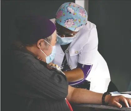  ?? ALLEN MCINNIS ?? A health-care worker gives a COVID-19 vaccine to a homeless person on Tuesday, part of a campaign by the Welcome Hall Mission to get the homeless population protected. Most of the people working on the site are not nurses, but drawn upon from other medical profession­s.