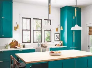  ?? HGTV HOME BY SHERWIN-WILLIAMS ?? Many homeowners are getting bored with white or gray kitchen cabinets and going for a bolder look, such as these vibrant teal cabinets.