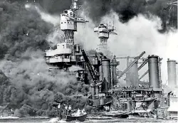  ??  ?? Sailors in a motor launch rescue a survivor from the water alongside the sunken battleship USS West Virginia during or shortly after the Japanese air raid on Pearl Harbour.