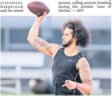  ?? — AFP photo ?? Kaepernick looks to pass during his NFL workout held at Charles R Drew high school in Riverdale, Georgia.