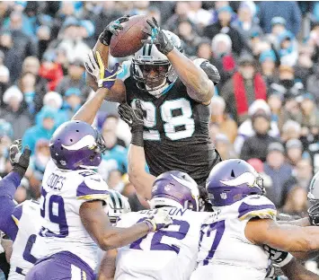  ?? GRANT HALVERSON/GETTY IMAGES ?? Carolina Panthers running back Jonathan Stewart leaps into the end zone to score the game-winning touchdown against the Minnesota Vikings on Sunday in Charlotte, N.C.