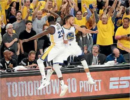  ?? PHOTO: USA TODAY SPORTS ?? Warriors guard Stephen Curry, right, celebrates with forward Draymond Green during their title-clinching win over the Cleveland Cavaliers.