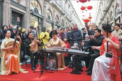  ?? WU NIAN / CHINA DAILY ?? Chinese and Belgian artists perform at the lantern-hanging ceremony at the Saint-Hubert Royal Galleries in Brussels on the first day of Chinese New Year on Feb 16. Observing the Chinese tradition has become more common around the world.
