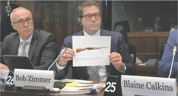  ?? PARLVU.PARL.GC.CA ?? Conservati­ve MP Bob Zimmer held up pictures of a number of hunting rifles at the Standing Committee on Public Safety
and National Security on Thursday. Some hunting rifles will be prohibited in an amendment to Bill C21.