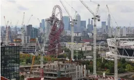  ?? Photograph: Simon Turner/Alamy ?? The ArcelorMit­tal Orbit tower surrounded by cranes in the Olympic Village area in east London.