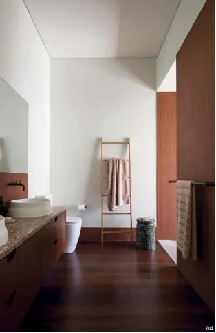  ?? ?? 04 04 The family’s shared bathroom showcases terrazzo, timber and tile.
05 Cheerful colours differenti­ate the ensuite, where sky blue stack-bonded tiles line the shower.
06 Blue walls and joinery offset the ensuite’s elegant marble benchtop.