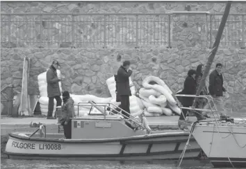  ??  ?? RELATIVES of missing persons from the Costa Concordia cruise ship at Giglio island. — Reuters