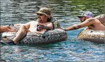  ?? PHOTOS BY TOM MCCARTHY JR. / FOR AMERICAN-STATESMAN ?? Hernandez (left) and MacDonald float down the Comal River on Tuesday. Outfitters reacted strongly to an appeals court ruling paving the way to reinstate New Braunfels’ ban on cans and large coolers on city rivers.