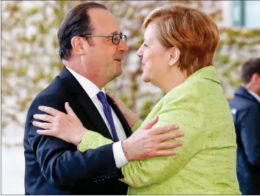  ??  ?? German Chancellor Angela Merkel welcomes outgoing French President Francois Hollande after his arrival in Berlin, Germany, on 8 May 2017.