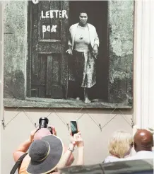  ??  ?? In this photograph of January 24, 2020, tourists take pictures of the District 6 Museum that commemorat­es the suburb of District 6 before it was destroyed in 1966