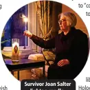  ?? ?? Survivor Joan Salter lights a candle.