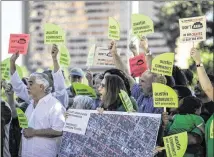  ?? RICARDO B. BRAZZIELL / AMERICAN-STATESMAN ?? Residents of the East Cesar Chavez Street area gather at Austin City Hall to oppose a proposed hotel in the neighborho­od. They worry it would add traffic and be out of character.