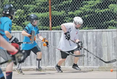  ?? CAROL DUNN/THE NEWS ?? A player with the Pavement Pounders tries to get the ball from Seth Gallant of the Pictou County Knights during a ball hockey tournament this weekend at the West Side Community Centre. The two teams played in the peewee division on Sunday.
