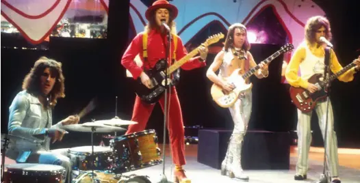  ??  ?? Glam rockers: Powell, Noddy Holder, Dave Hill and Jim Lea perform Mama Weer All Crazee Now on Top Of The Pops in 1972