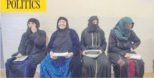  ?? RYAN REMIORZ / THE CANADIAN PRESS ?? Women from the Mosul district wait to see a doctor at the Canadian funded clinic at the Dibaga internal displaced persons camp in Iraq. The facility one of several projects Canada is supporting in Iraq as part of its efforts to help those affected by...