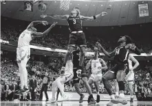  ?? Eric Gay / Associated Press ?? Texas Tech’s Jahmi’us Ramsey rejects Texas guard Courtney Ramey on a drive to the hoop in the second half.