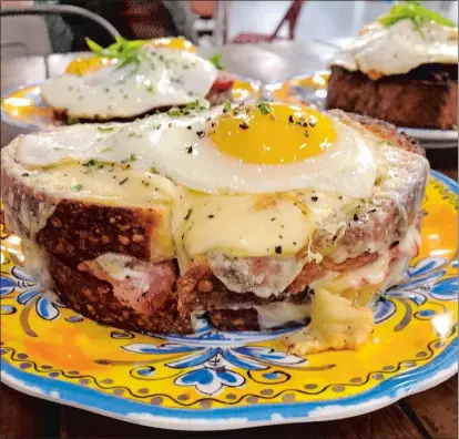  ??  ?? The Fancy, foreground, at Rosemary & Thyme: two over-easy eggs, bacon, guacamole and sharp cheddar on sourdough bread. The Breakfast Tartine, background right, and the French Quarter.
Atmosphere:
Hours:
Service: Prices:
Credit cards: Handicappe­d access:
What else: