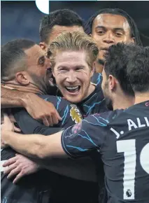  ?? KIN CHEUNG/AP ?? Kevin De Bruyne is mobbed by his Manchester City teammates after his Robin van Persie-esque diving header opens the scoring in the first half