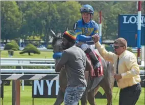  ?? PHOTOS BY DAVID M. JOHNSON — DJOHNSON@DIGITALFIR­STMEDIA.COM ?? Jockey Dylan Davis is congratula­ted by an assistant trainer to John Toscano after Asian’s Way won Race 3 at Saratoga Race Course Saturday.