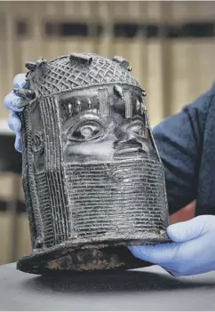  ??  ?? Neil Curtis, Head of Museums and Special Collection­s at the University of Aberdeen, top, with the bronze sculpture, which is considered one of the finest examples of Benin Late Period Art