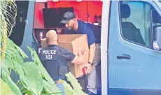  ?? ?? Homeland Security Investigat­ion agents load a box into a car at the entrance of Combs’s home at Star Island in Miami Beach.