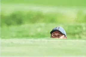  ?? JEFF CURRY/USA TODAY SPORTS ?? Tiger Woods looks out from a bunker on the 17th hole during his first round of the PGA Championsh­ip at Bellerive Country Club.