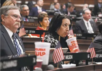  ?? Jessica Hill / Associated Press ?? State Rep. Anne Dauphinais R-Killingly, takes a sip from a big gulp soda as Gov. Ned Lamont delivers his budget address at the state Capitol in Hartford on Wednesday. Lamont has proposed a tax on sugary drinks in his first budget.