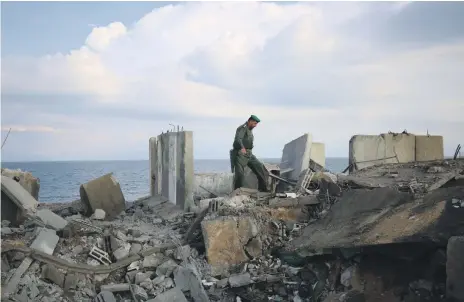  ?? AFP ?? A member of the Hamas security forces walks on debris after an Israeli air strike in the Gazan city of Rafah yesterday