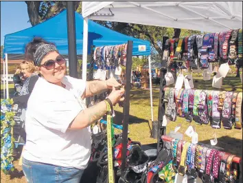  ??  ?? Krissy LaFlech displays her colorful handmade dog collars for visitors . Forty-three vendors set up shop during the event.