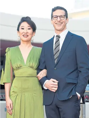  ?? KEVORK DJANSEZIAN GETTY IMAGES ?? Canadian-born Sandra Oh and Andy Samberg, who respective­ly star as TV sleuths on Killing Eve and Brooklyn Nine-Nine, will host the Golden Globe Awards tonight.