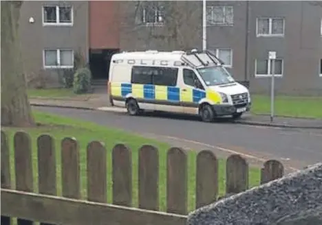  ??  ?? The police van sitting outside the flats in Dundee’s Thurso Crescent.