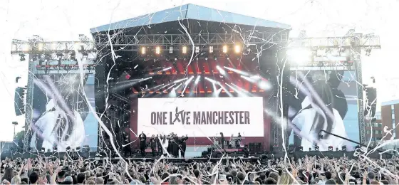 ?? DAVE HOGAN/THE ASSOCIATED PRESS ?? Ariana Grande, onstage in white, performs at the One Love Manchester tribute concert in Manchester, north western England, on Sunday. One Love Manchester is raising money for those affected by the bombing at the end of Ariana Grande’s concert in...