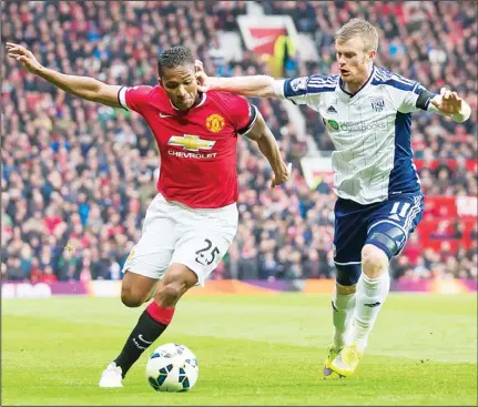  ??  ?? Manchester United’s Antonio Valencia (left), is held at bay by West Bromwich Albion’s Chris Brunt during the English Premier League soccer match
between Manchester United and West Bromwich Albion at Old Trafford Stadium, Manchester, England, May 2. (AP)