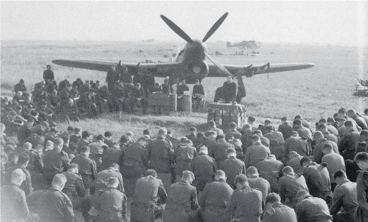  ?? DEPARTMENT OF NATIONAL DEFENCE, PL31433 ?? 143 Wing in prayer at Lantheuil, Normandy, where Al Davidson served as one of the radio operators who guided pilots. “The powerful performanc­e of the Canadian Typhoons would have been impossible,” writes historian Hugh Halliday, “but for the herculean efforts of the groundcrew back at Lantheuil. It was a triumph of teamwork.”