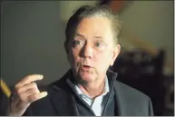  ?? Ned Gerard / Hearst Connecticu­t Media ?? Gov. Ned Lamont announced Monday that he will lift most outdoor-related COVID-19 restrictio­ns effective May 1, including the use of masks, and all remaining business restrictio­ns on May 19, all but returning the state to pre-pandemic level activity.