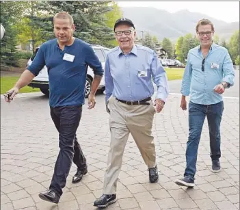  ?? Kevork Djansezian
Getty Images ?? MEDIA MOGUL Rupert Murdoch, center, is f lanked by sons James, right, and Lachlan as they arrive at the Allen & Co. annual conference at the Sun Valley Resort in 2013.