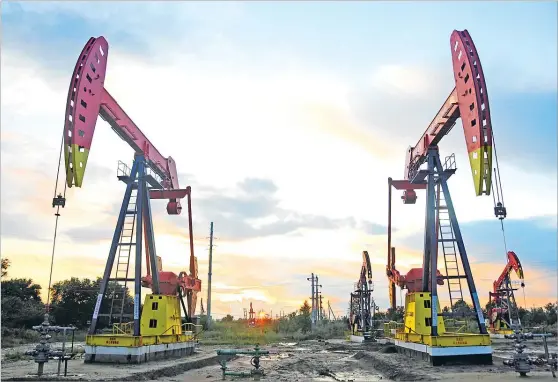  ?? Picture: REUTERS/STRINGER ?? Pumpjacks are seen during sunset at the Daqing oil field in Heilongjia­ng province, China.