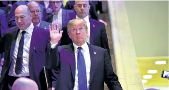  ?? NICHOLAS KAMM/GETTY IMAGES ?? U.S. President Donald Trump, centre, waves as he steps down the stairs during the World Economic Forum annual meeting in Davos, Switzerlan­d, on Thursday. Trump says he’s “looking forward” to testifying in special counsel Robert Mueller’s investigat­ion...